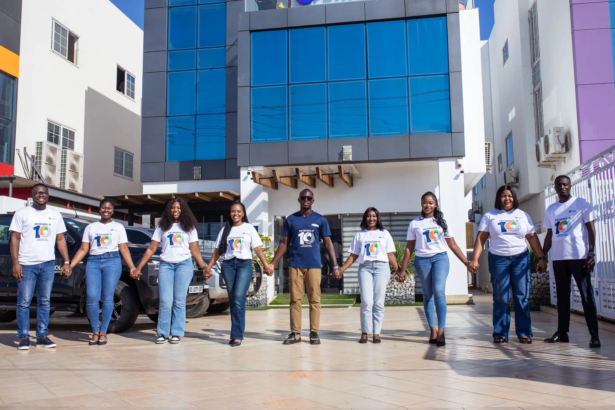 PETROSOL colleagues holding hands outside the company office